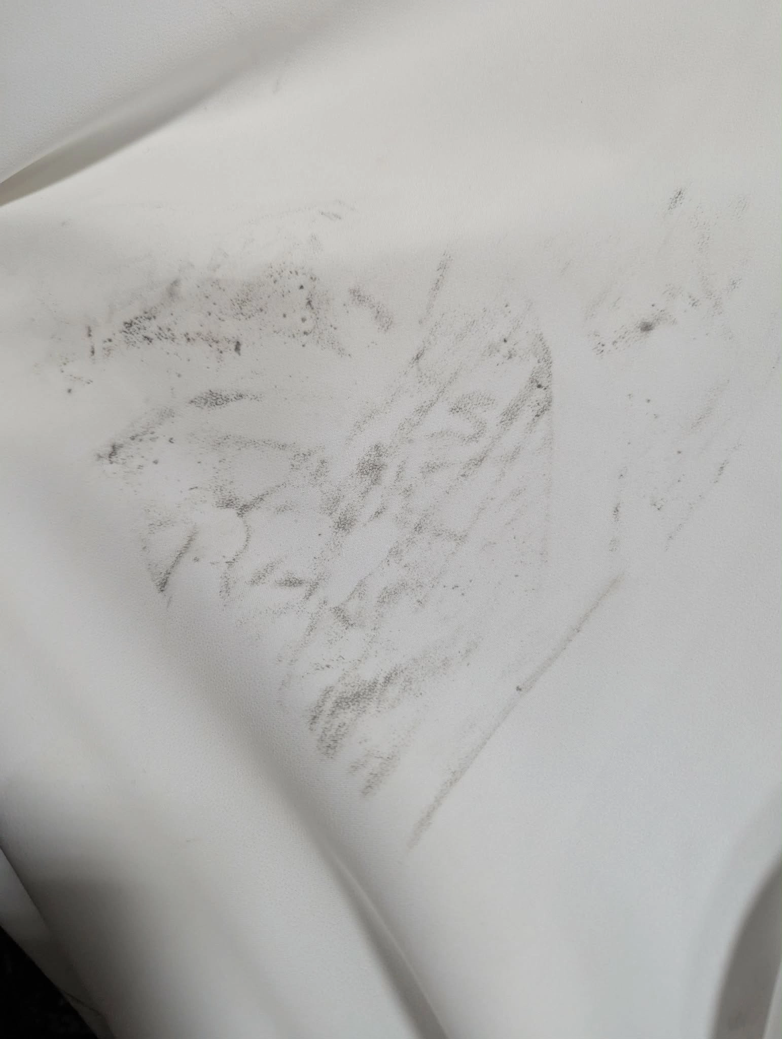 Close-up of heavy grease stain on white fabric